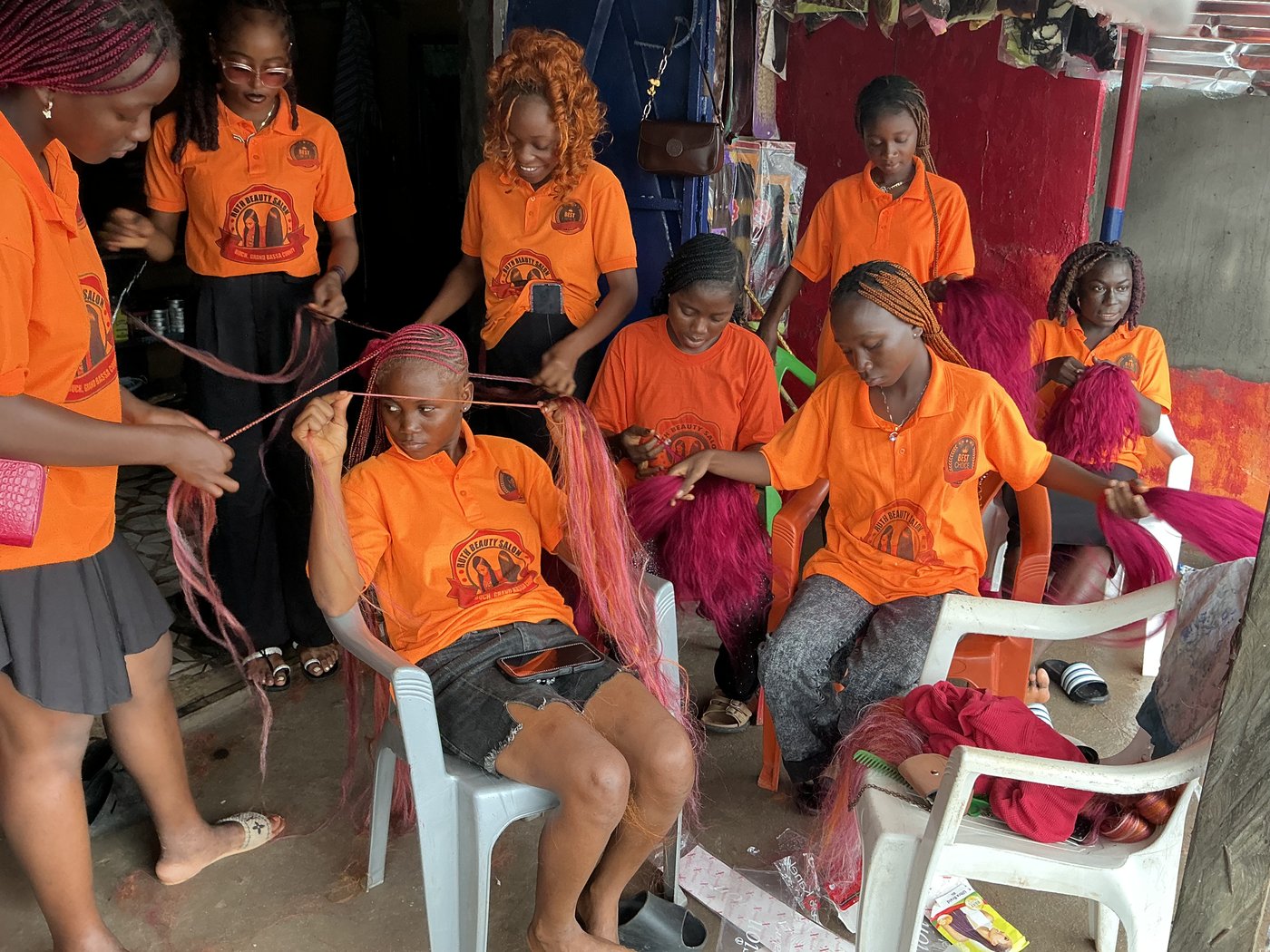Face of Beauty trainees braiding hair in Buchanan